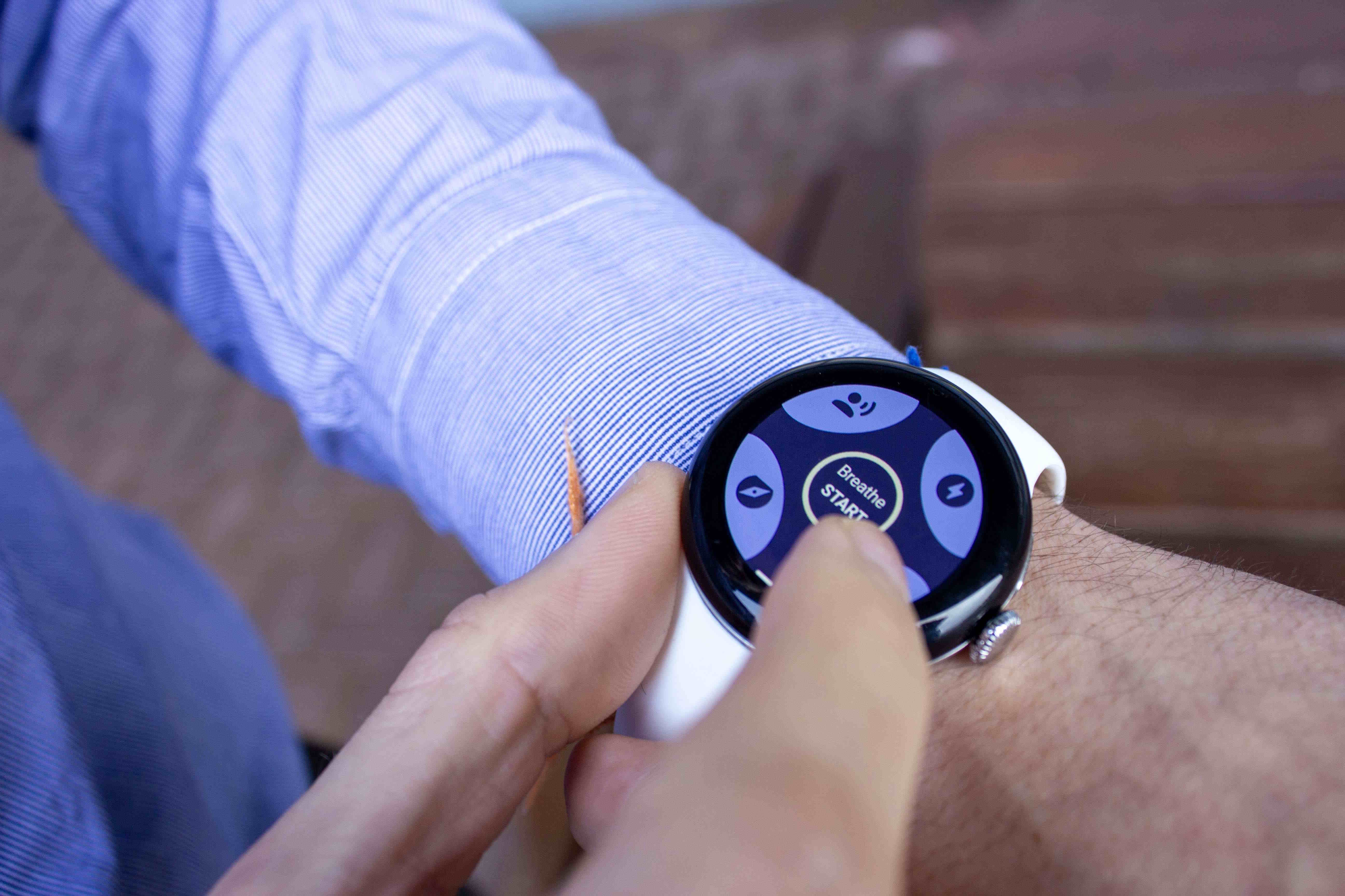 Hands wearing Google Pixel Watch 2 alongside Milbotix SmartSocks sensor for physiological monitoring